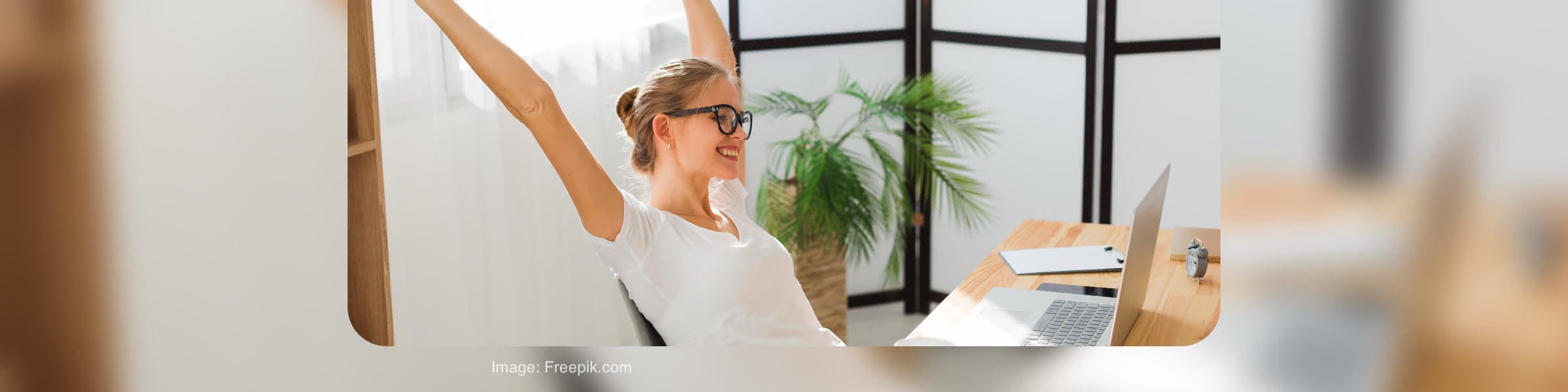 Recruiter celebrating at a laptop in an office